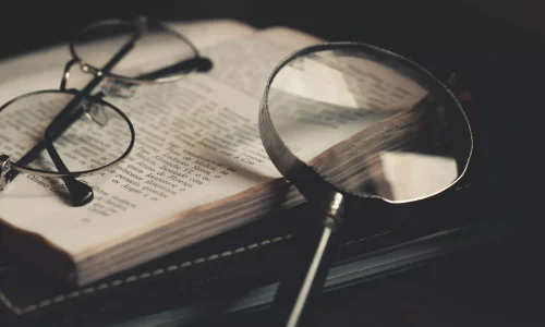 Magnifying glass with book for Keyword Research by Laurince Ratac